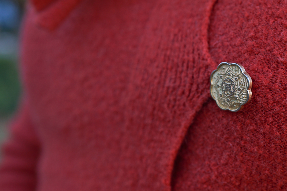 The most intricate button; also, metal and thus impervious to drycleaners ham-fisted ways